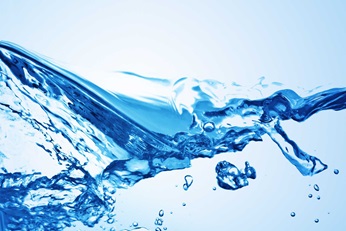 Water splashing on light blue background