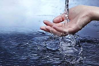 Water streaming to woman's hand