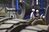 Two employees with turbines in service center 