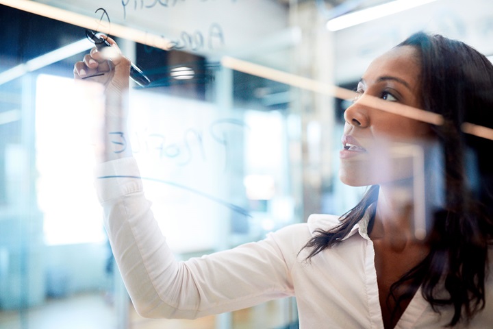 Woman writing on glass