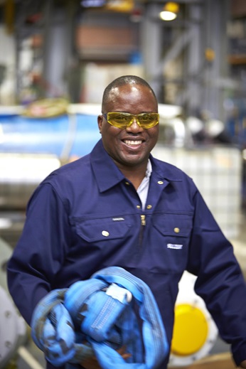 Sulzer employee at work smiling into camera