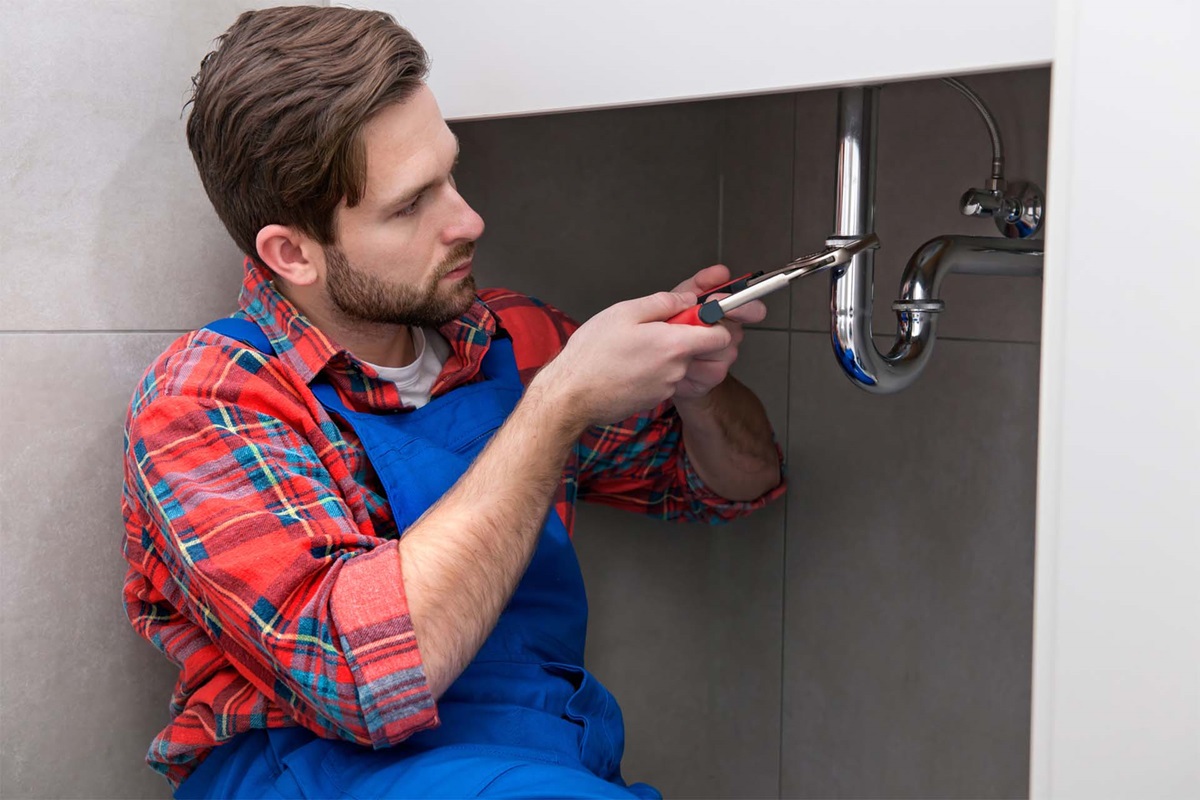 Plumber working at water pipe