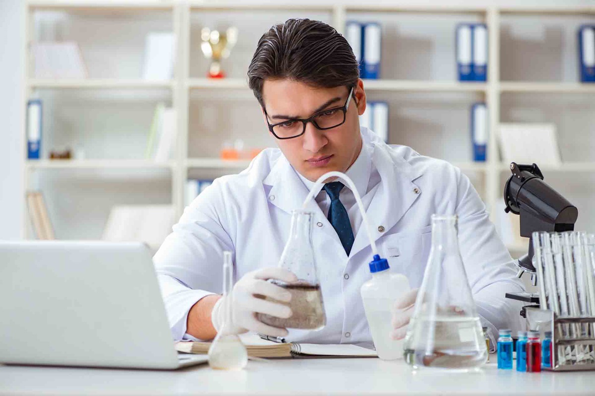 Young researcher scientist doing a water test contamination experiment in the laboratory