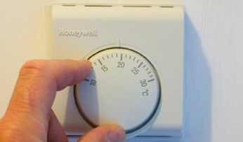 Thermostat controls being adjusted.