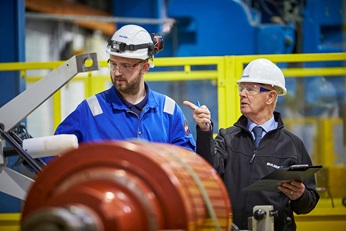 Engineers discussing the repair of a generator.