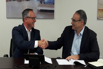 Jim Mugford and Dominique Llonch signing the deal.