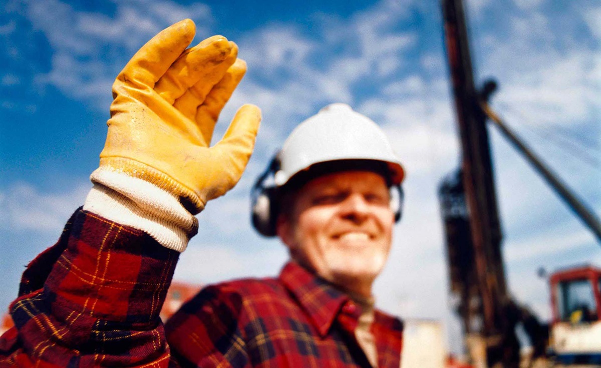 Man with yellow glove, helmet and red shirt