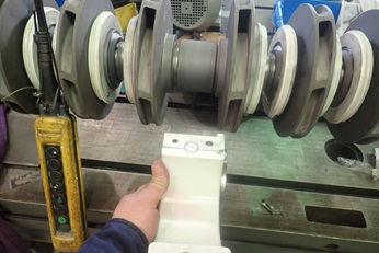 Parts of a pump being checked by service engineer