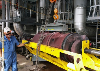 Sulzer employees installing pump components on site.