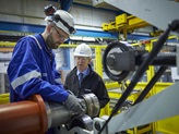 Engineer and inspector checking pump in service centre