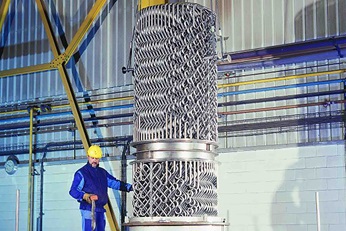 Employee installing heat exchanger - Sulzer Mixer Reactor SMR