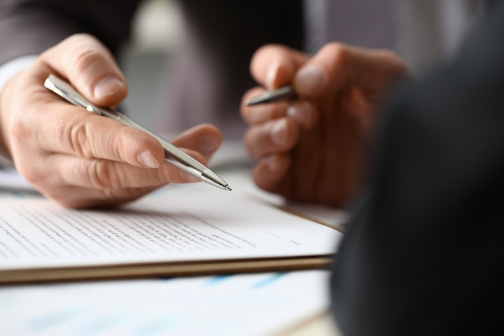 Close up of hands holding pens