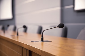 Empty speaker seats in conference room