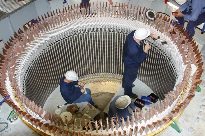 Field service engineers repairing a generator on site