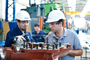 Pump being serviced by two engineers.