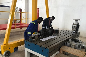 Specialists inspecting a pump on display at Sulzer Mansa.