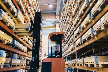Man working with forklift in warehouse