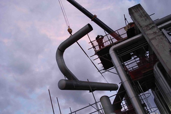 Onsite piping assembly of Tower Field Service with crane