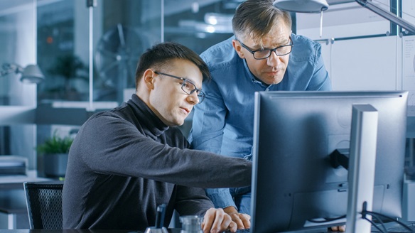 Engineers around computer