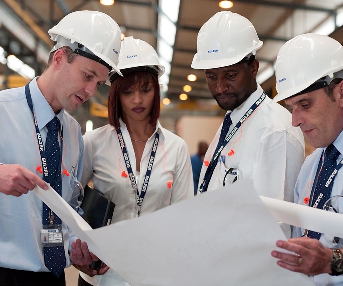Sulzer engineers working together on plans
