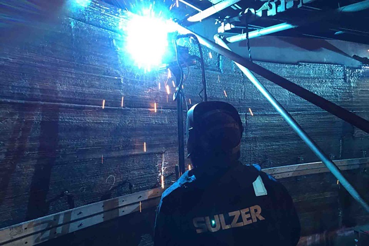Welder in column doing weld ov