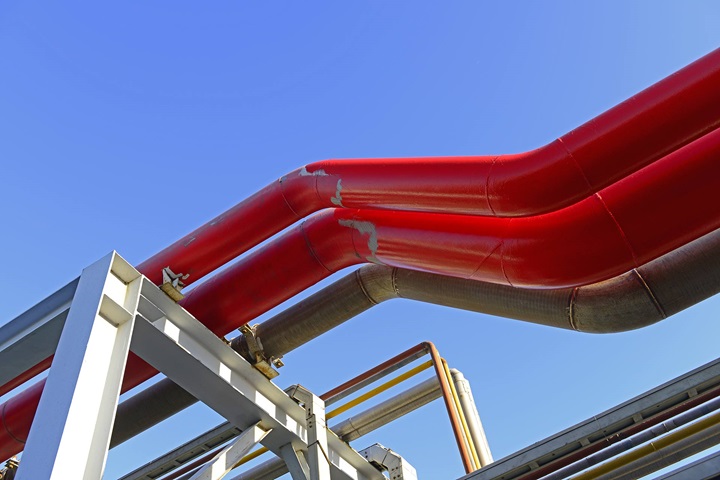 Red pipes in front of blue sky