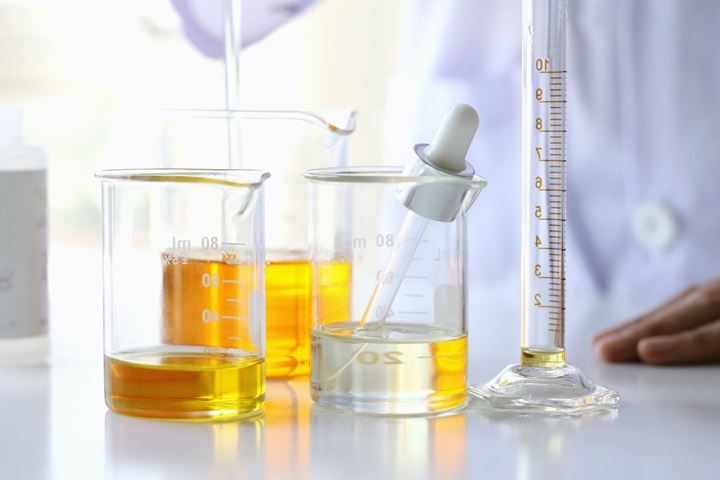 Person in laboratory with oleochemicals