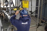 Onsite piping assembly of Tower Field Service with employee